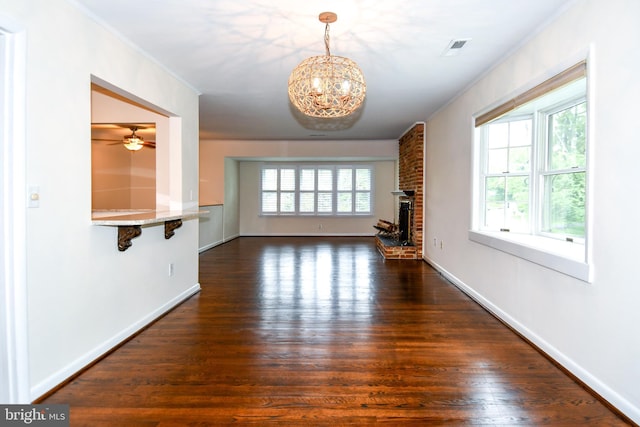 130 Great Lake Dr, Annapolis, MD 21403 - unfurnished living room featuring dark wood-style floors, ornamental molding, a fireplace, a chandelier, and baseboards