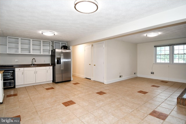 130 Great Lake Dr, Annapolis, MD 21403 - kitchen with stainless steel fridge with ice dispenser, open shelves, dark countertops, a textured ceiling, and light tile patterned floors