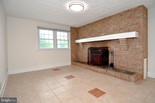 130 Great Lake Dr, Annapolis, MD 21403 - unfurnished living room featuring a wood stove, a textured ceiling, tile patterned floors, and baseboards