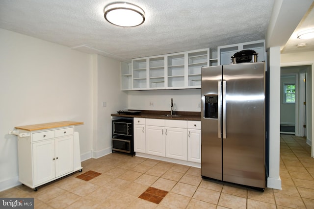 130 Great Lake Dr, Annapolis, MD 21403 - kitchen with stainless steel fridge with ice dispenser, open shelves, a sink, white cabinets, and a textured ceiling