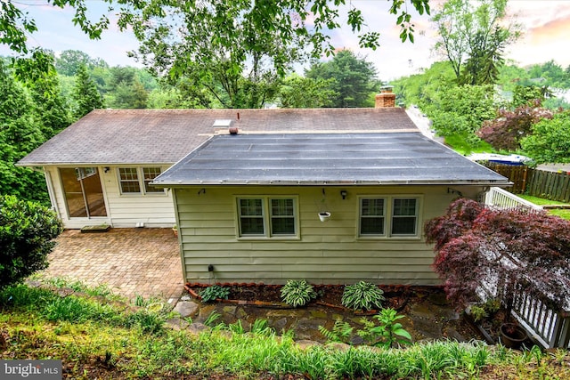 130 Great Lake Dr, Annapolis, MD 21403 - view of front facade with a chimney, a patio, and fence