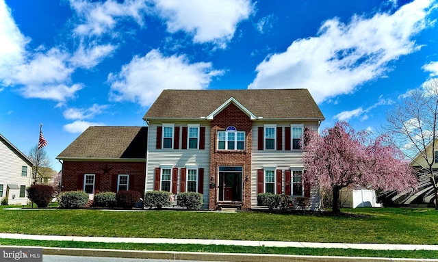 colonial inspired home with a front yard