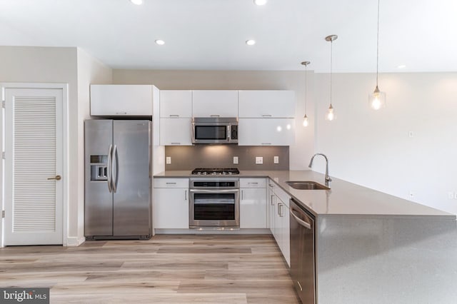 1350 Maryland Ave NE Unit 116, Washington, DC 20002 - kitchen featuring a sink, stainless steel appliances, light wood-type flooring, and white cabinetry