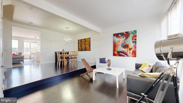 living area featuring baseboards and wood finished floors