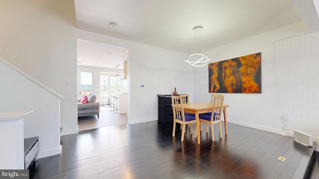 dining space with baseboards and dark wood-type flooring