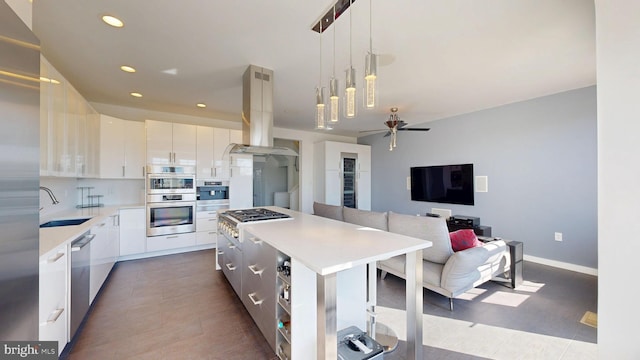 kitchen featuring appliances with stainless steel finishes, light countertops, island exhaust hood, a kitchen island, and modern cabinets