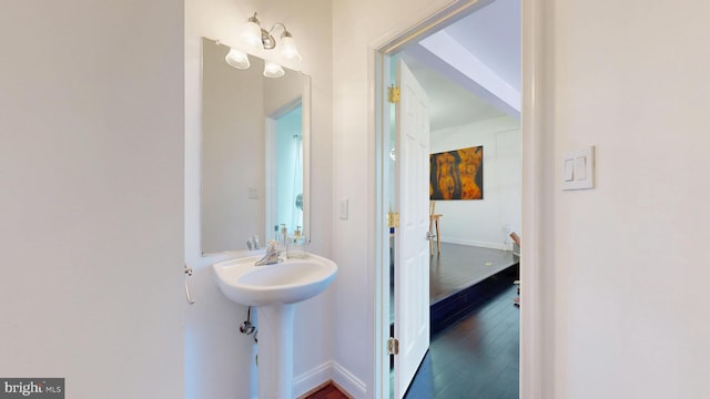 bathroom featuring baseboards and wood finished floors