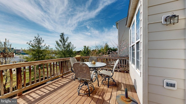 wooden terrace with outdoor dining space