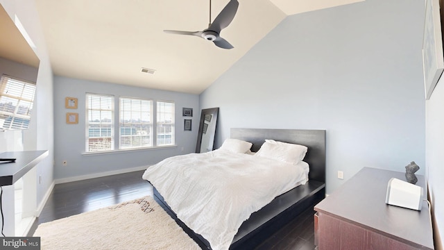 bedroom featuring ceiling fan, dark wood-style flooring, visible vents, baseboards, and high vaulted ceiling