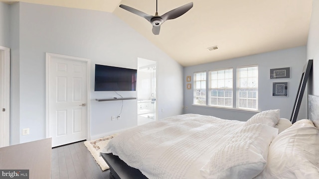 bedroom with a ceiling fan, visible vents, wood finished floors, lofted ceiling, and ensuite bath