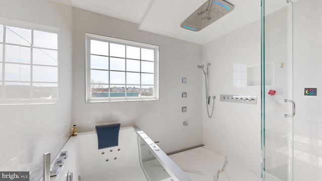 bathroom featuring a whirlpool tub, marble finish floor, and a stall shower
