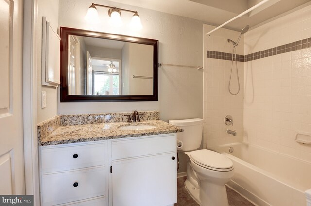 bathroom featuring toilet, shower / bath combination, and vanity