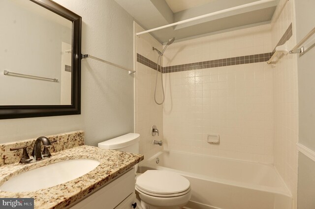 bathroom with vanity, bathing tub / shower combination, and toilet