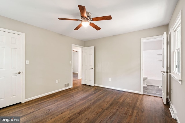 unfurnished bedroom with ceiling fan, visible vents, dark wood finished floors, baseboards, and connected bathroom