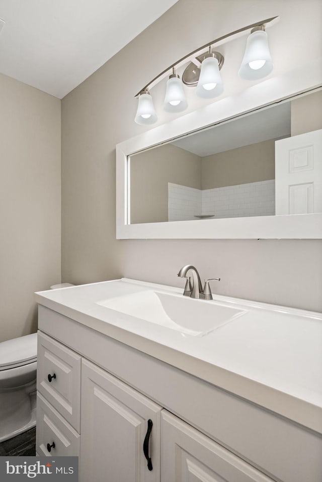 bathroom featuring vanity and toilet