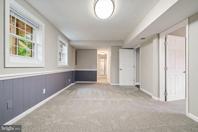 unfurnished room featuring carpet floors and baseboards