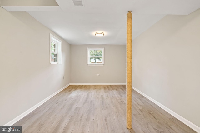 below grade area featuring visible vents, light wood-style floors, and baseboards