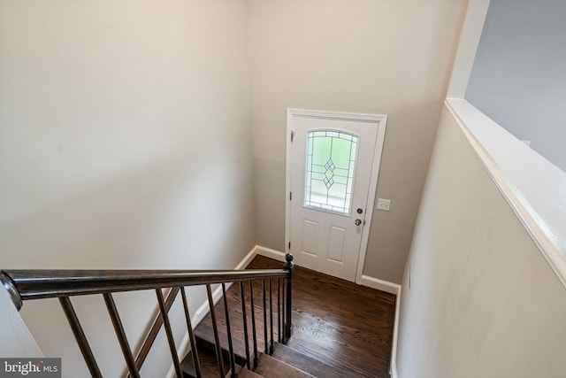 foyer with baseboards and dark wood finished floors