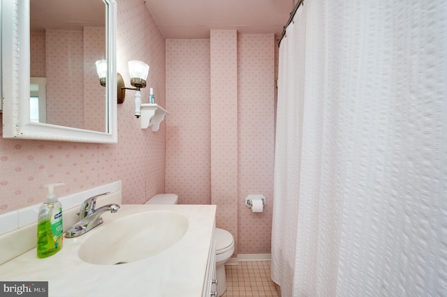 full bath with vanity, tile patterned floors, toilet, and wallpapered walls