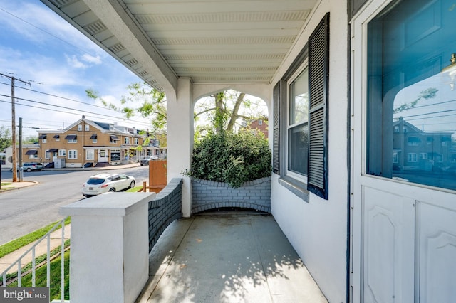 exterior space featuring covered porch and a residential view