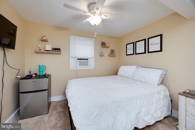 carpeted bedroom featuring baseboards, freestanding refrigerator, and a ceiling fan