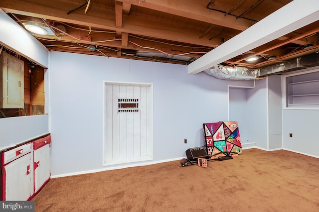 below grade area with baseboards, carpet flooring, and electric panel
