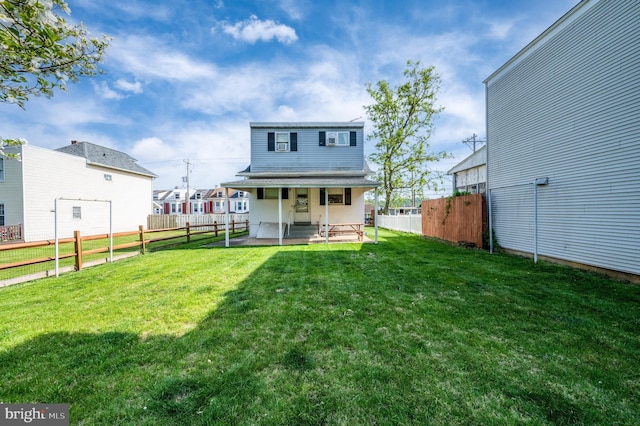 back of house with a yard, a patio, a residential view, and a fenced backyard