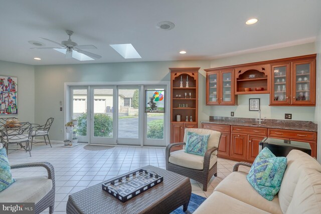 living area with light tile patterned floors, a skylight, and recessed lighting