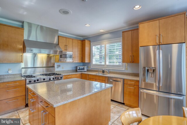 kitchen with crown molding, a sink, wall chimney exhaust hood, stainless steel appliances, and light tile patterned floors