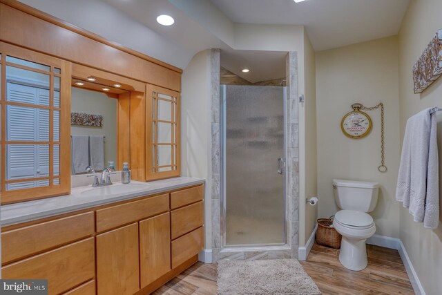 full bathroom with vanity, baseboards, a shower stall, and toilet