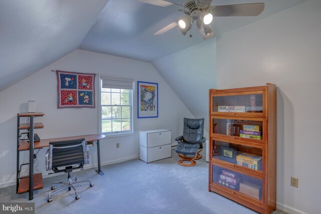 carpeted office space with a ceiling fan, baseboards, and vaulted ceiling