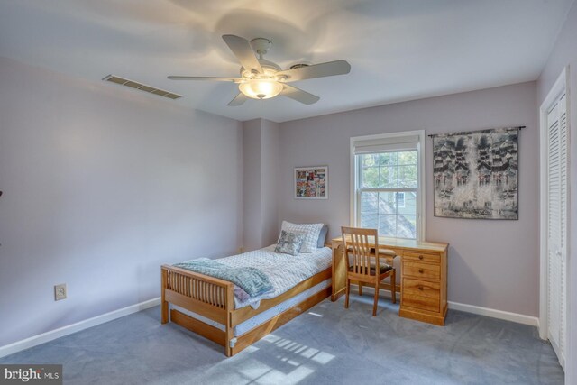 carpeted bedroom with visible vents, baseboards, ceiling fan, and a closet