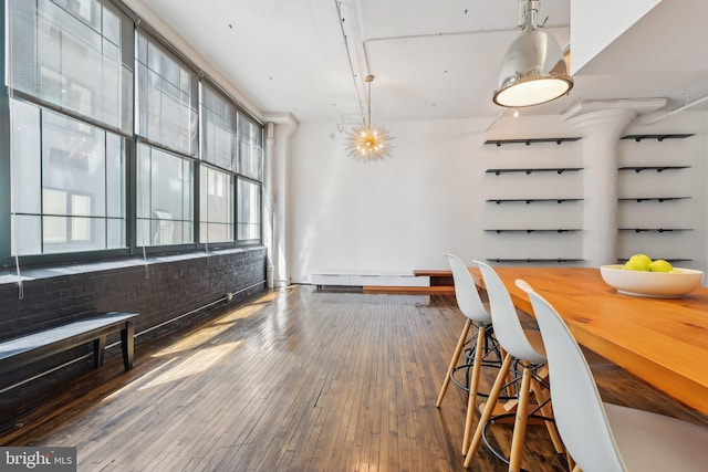 dining room featuring a healthy amount of sunlight and hardwood / wood-style flooring