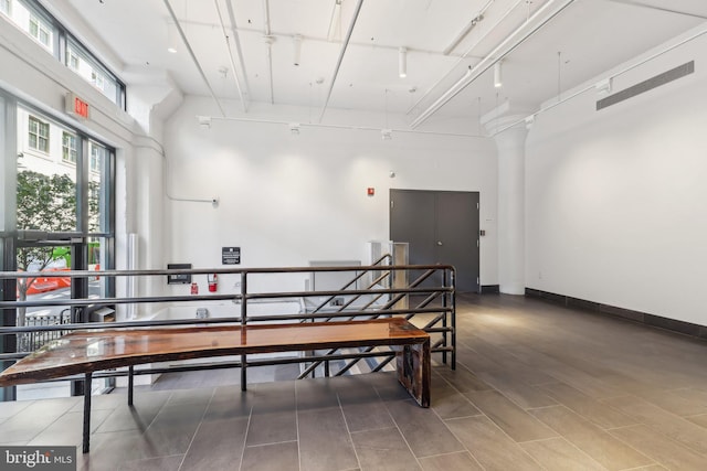 interior space with a high ceiling and wood finished floors