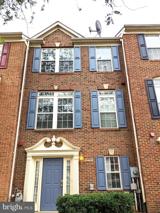 view of property with brick siding
