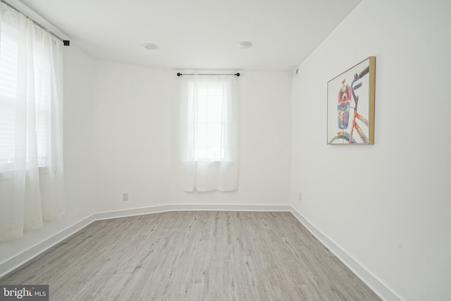 unfurnished room featuring baseboards and wood finished floors