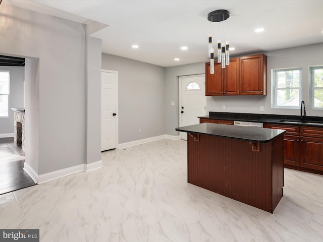 kitchen featuring marble finish floor, a kitchen island, baseboards, a sink, and hanging light fixtures
