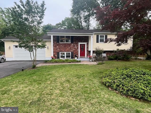133 Teal Dr, Pasadena, MD 21122 - raised ranch featuring driveway, a garage, a front lawn, and brick siding