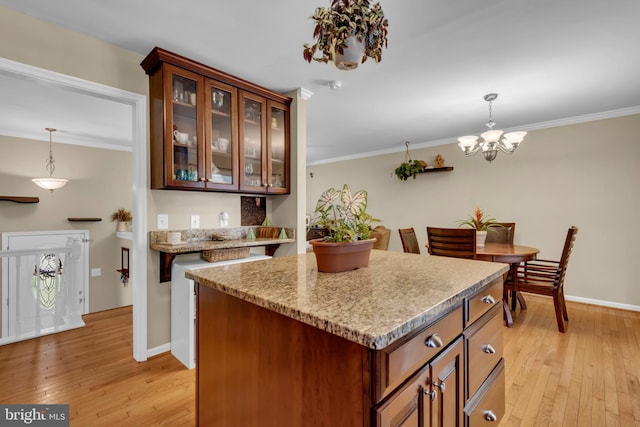 133 Teal Dr, Pasadena, MD 21122 - kitchen featuring light wood-style flooring, a kitchen island, hanging light fixtures, and ornamental molding