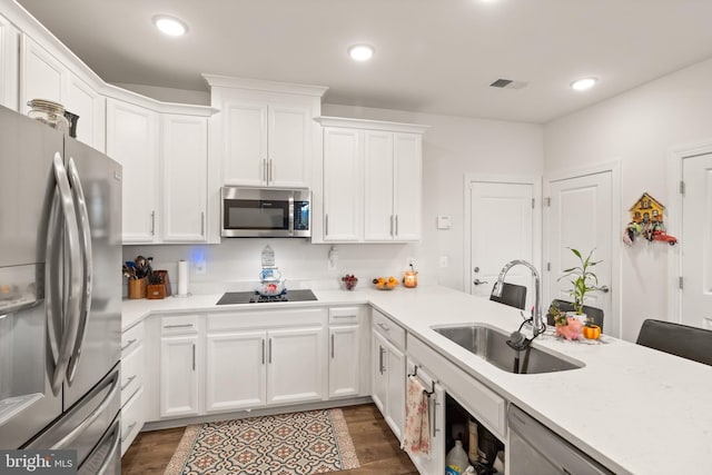 10424 Ratcliffe Trl, Manassas, VA 20110 - kitchen with light countertops, appliances with stainless steel finishes, dark wood-style flooring, and a sink