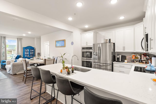10424 Ratcliffe Trl, Manassas, VA 20110 - kitchen featuring white cabinets, light countertops, appliances with stainless steel finishes, and a sink