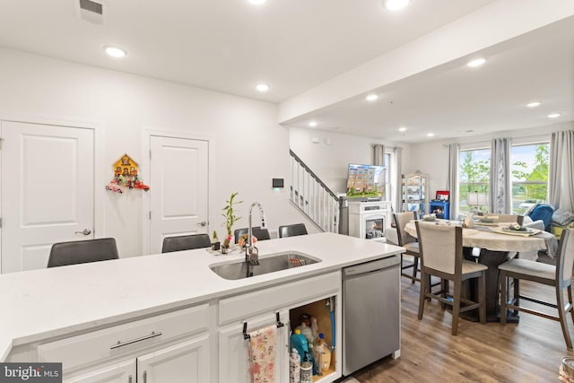 10424 Ratcliffe Trl, Manassas, VA 20110 - kitchen with a sink, open floor plan, white cabinetry, stainless steel dishwasher, and light countertops