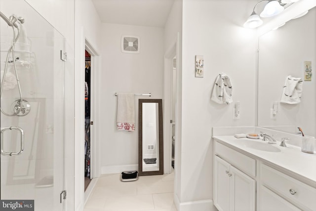 10424 Ratcliffe Trl, Manassas, VA 20110 - full bath featuring vanity, a walk in closet, a shower stall, and tile patterned floors