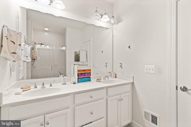 10424 Ratcliffe Trl, Manassas, VA 20110 - bathroom featuring double vanity, visible vents, a stall shower, and a sink
