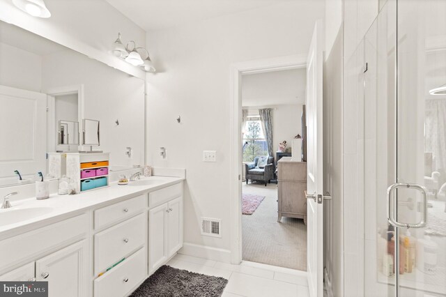 10424 Ratcliffe Trl, Manassas, VA 20110 - ensuite bathroom featuring a sink, tile patterned floors, a stall shower, double vanity, and connected bathroom
