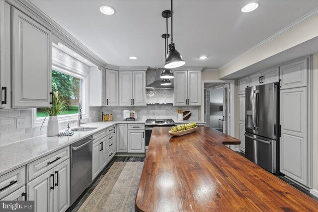 1301 Kelly Ct, Herndon, VA 20170 - kitchen with stainless steel appliances, butcher block counters, a sink, wall chimney exhaust hood, and tasteful backsplash