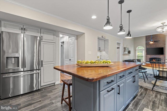 1301 Kelly Ct, Herndon, VA 20170 - kitchen with stainless steel fridge, butcher block counters, wood finish floors, open floor plan, and ornamental molding