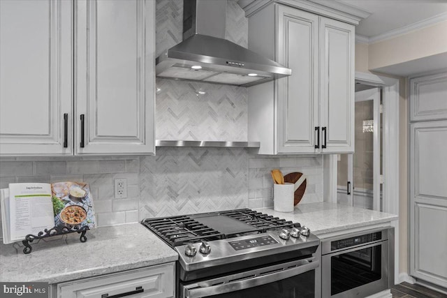 1301 Kelly Ct, Herndon, VA 20170 - kitchen featuring wall chimney exhaust hood, gas range, tasteful backsplash, white cabinets, and ornamental molding
