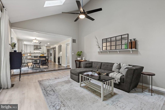 1301 Kelly Ct, Herndon, VA 20170 - living area featuring high vaulted ceiling, light wood-type flooring, ceiling fan, baseboards, and a skylight