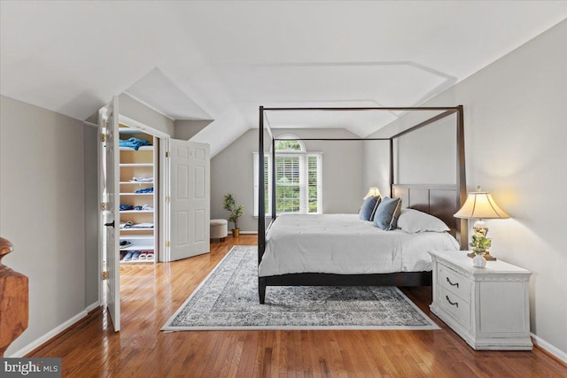 1301 Kelly Ct, Herndon, VA 20170 - bedroom with wood finished floors, vaulted ceiling, and baseboards